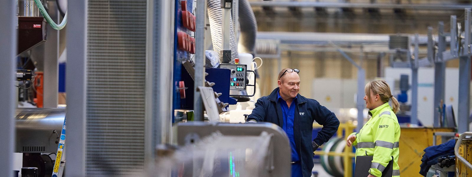 Factory worker talking to office employee