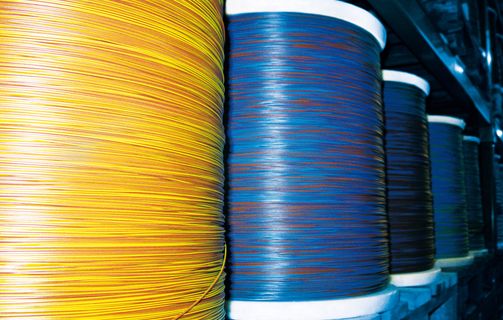 Blue and yellow automotive cables on large coils